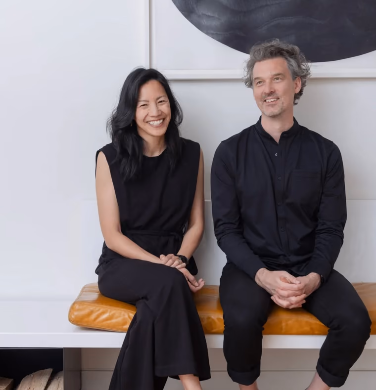 Nancy Chao and Luc Johnston seated in a bright studio interior
